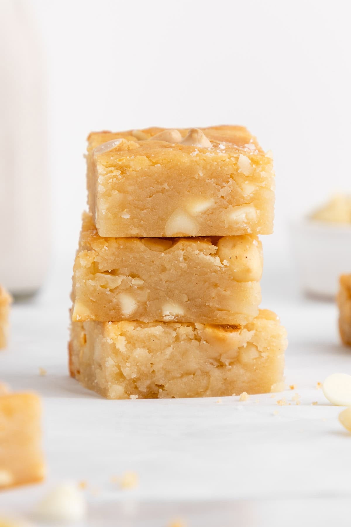 a stack of vegan white chocolate macadamia nut blondies