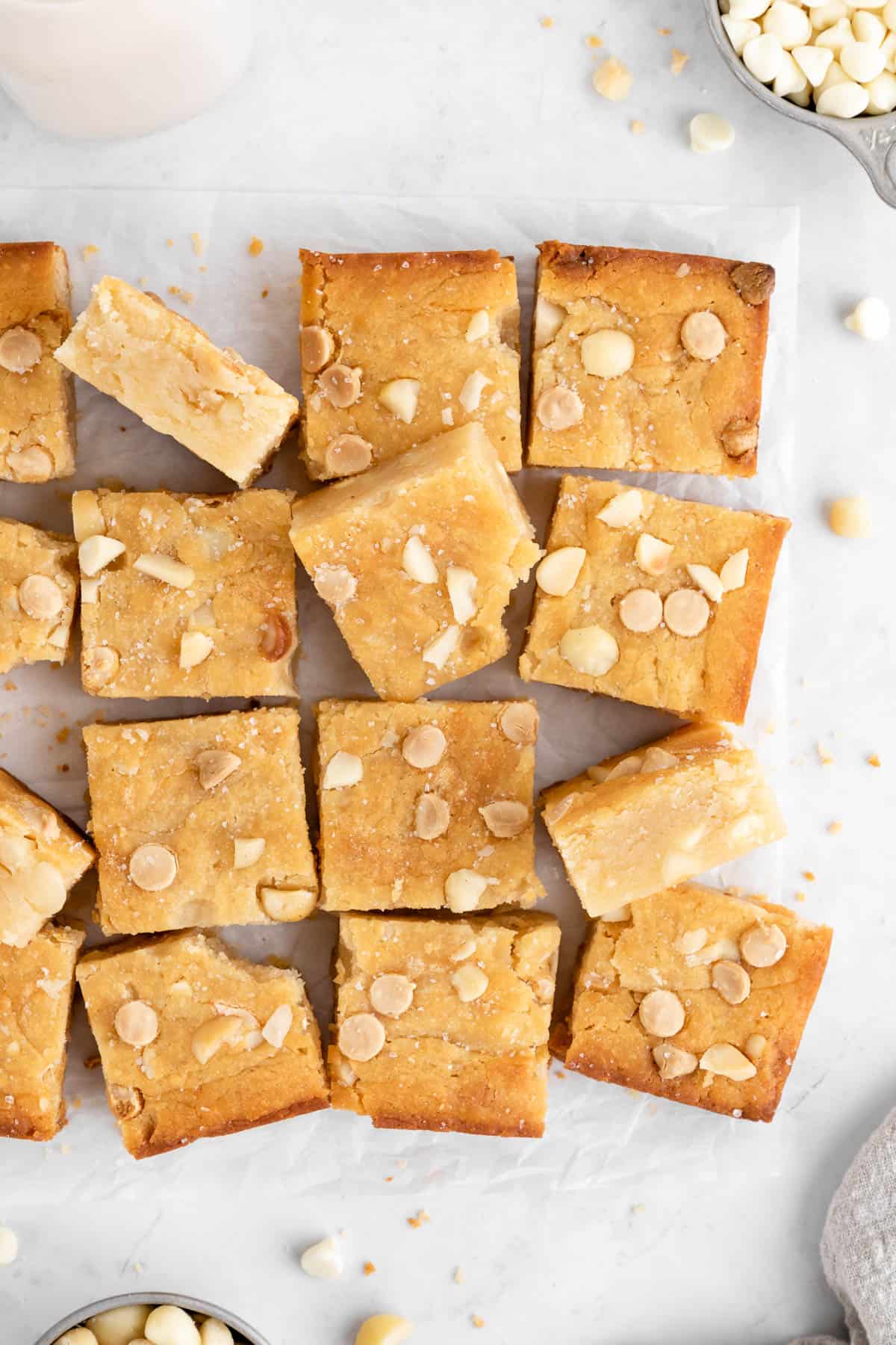 a pile of vegan white chocolate macadamia nut blondies