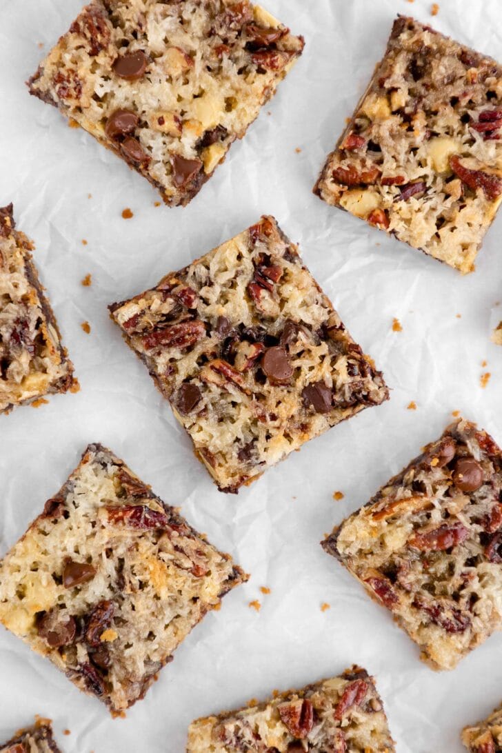 a close up photo of vegan seven layer magic cookie bars with sweetened condensed coconut milk