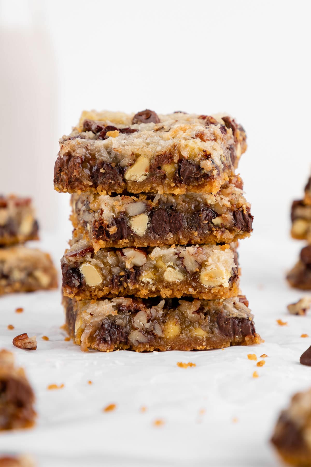 a stack of vegan seven layer magic cookie bars with sweetened condensed coconut milk