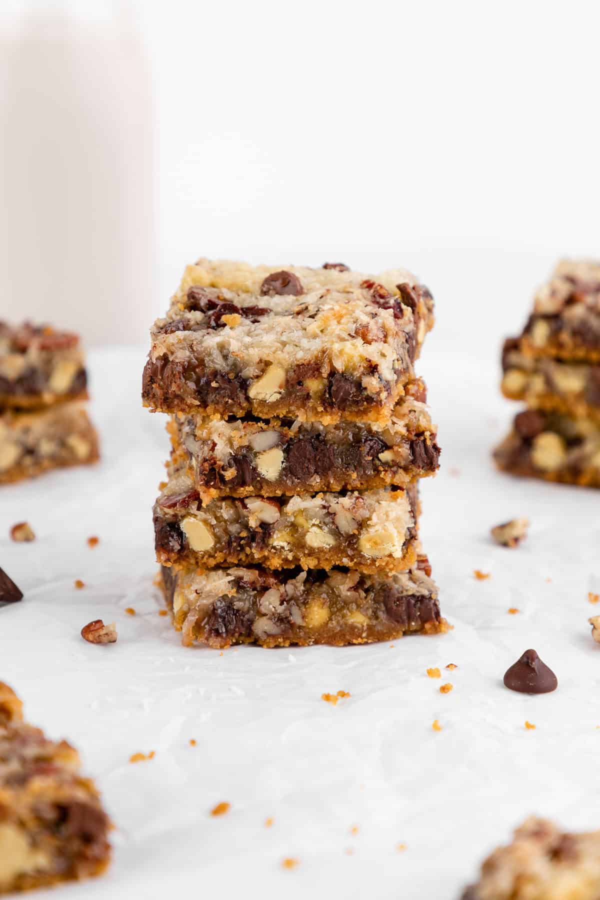 a stack of vegan seven layer magic cookie bars with sweetened condensed coconut milk
