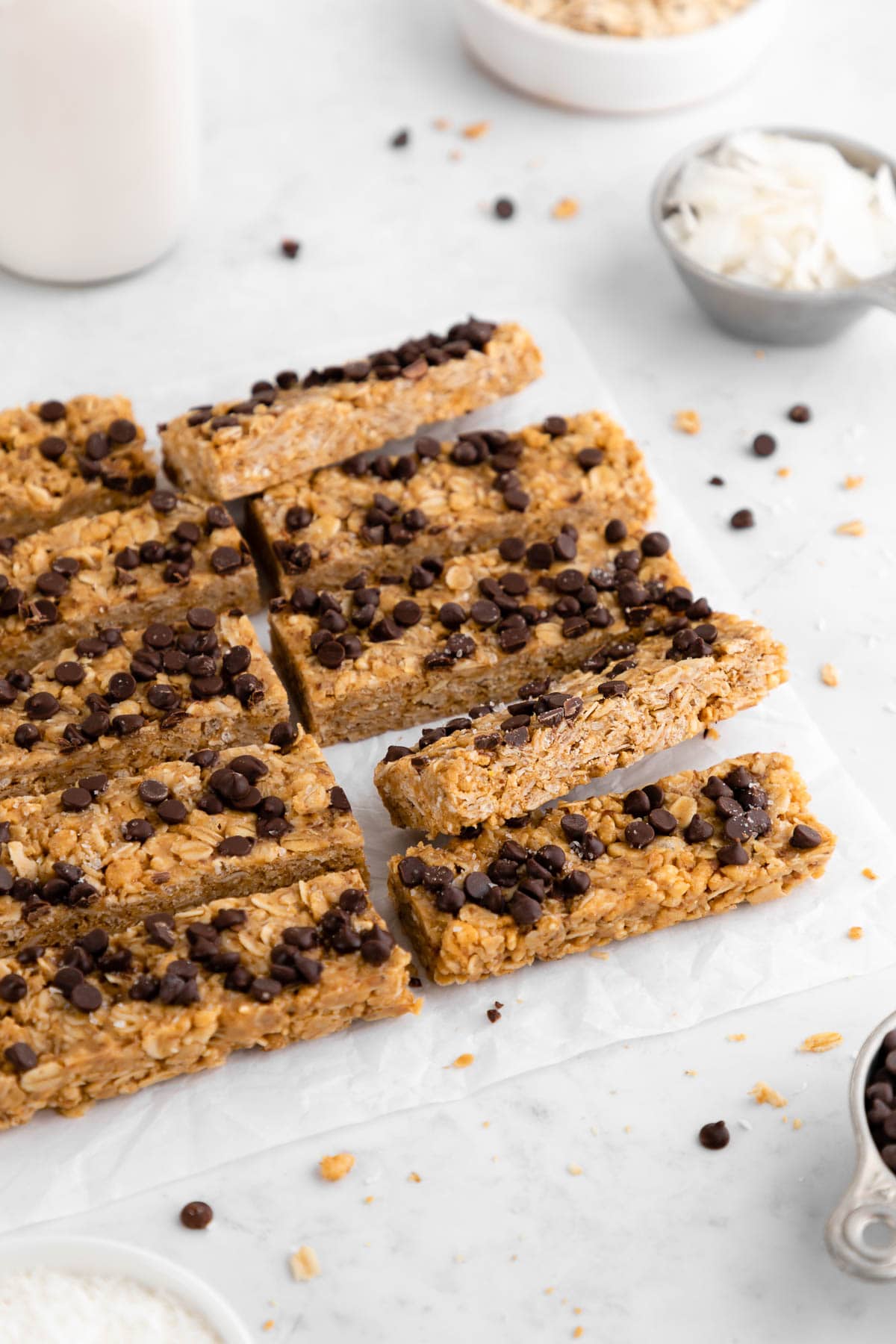 a pile of homemade coconut chocolate chip granola bars with peanut butter, oats, and honey