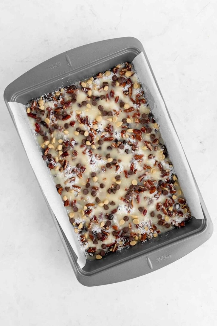 seven layer magic cookie bars inside a 9x13 baking pan