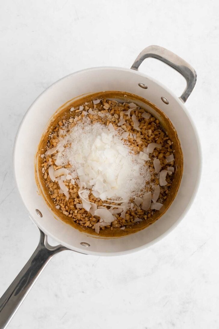 melting ingredients for homemade coconut chocolate chip granola bars in a saucepan