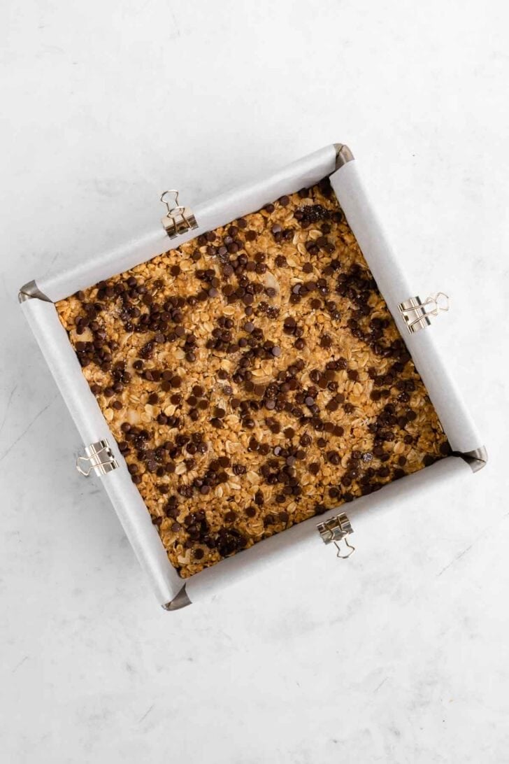 homemade coconut chocolate chip granola bars in a baking pan